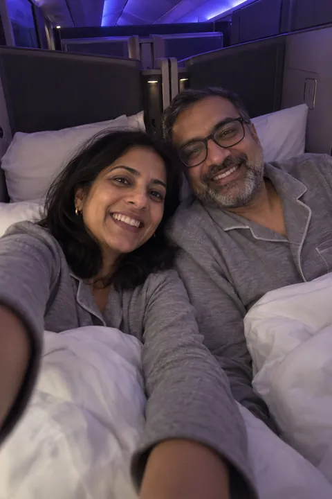 Priya and Arjun Nair in Qatar Airways business class
